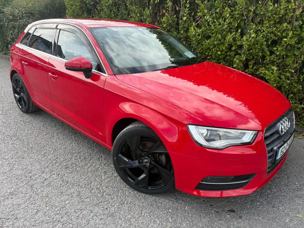 Red Audi A3 Sportback, side view showing the wind deflectors, at RS Motors, Clonakilty